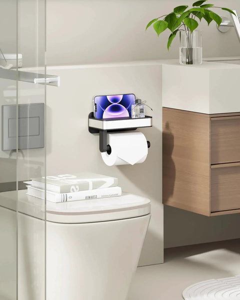 Toilet Paper Holder With Top Shelf And Phone Storage Adhesive And Screw Wall Mount Matte Black Bathroom Organizer in washroom.