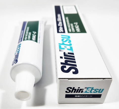 Shin-Etsu HIVAC-G silicone high vacuum grease tube with white nozzle beside Shin-Etsu box (side view).