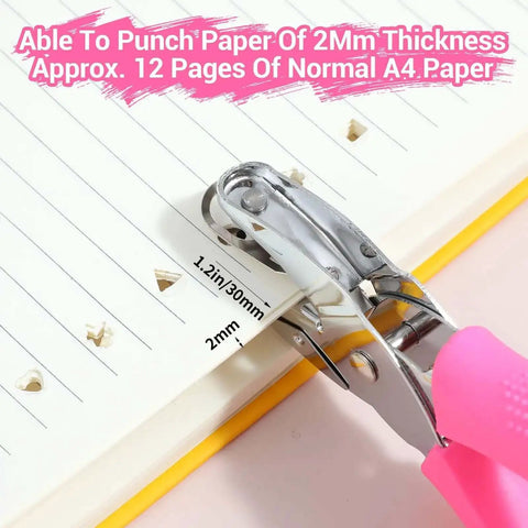 Close-up of Six Piece Craft Hole Punch Set for Scrapbooking, showing handheld punch with soft grip handles creating heart shapes in paper.