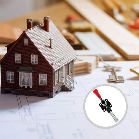 Push Pull Toggle Clamp With 42mm Stroke Horizontal Quick Release Hand Tool next to a model house on architectural blueprints.