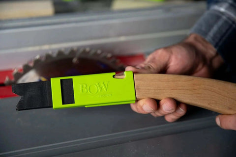 PushPRO PP1 Push Stick for Table Saws with EVA Tipped Push Block held by hand, showing green handle and black tip near saw blade.