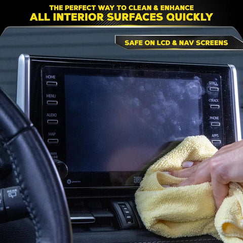 Person using Meguiars All Surface Interior Detailer on an LCD/navigation screen in a car interior.