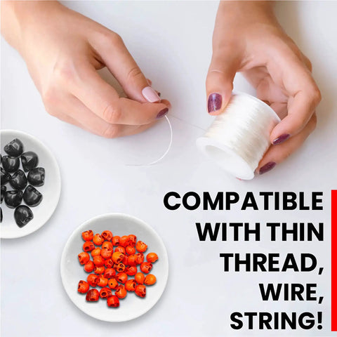 Hands threading spool with thin wire beside black and orange beads, showcasing compatibility of 40 Pack 12mm White Skull Beads For Jewelry Making.