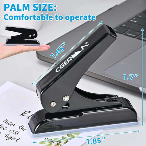 Heavy Duty Single Hole Punch With One Quarter Inch Hole 30 Sheet Capacity U Shaped Cutter Head next to a laptop