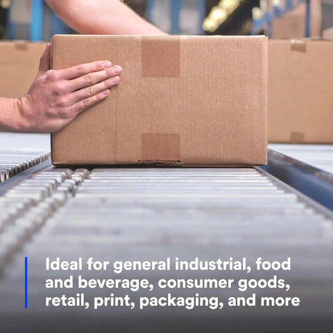 Cardboard shipping box on a warehouse conveyor belt; hand guiding the package.