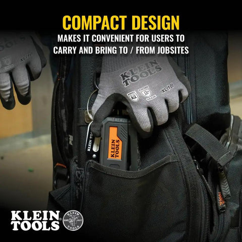 Person placing Magnetic Pocket Laser Level With 360 Degree Wall Attachment into a tool bag, showcasing compact design.