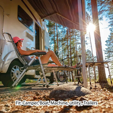 Person relaxing on a lounge chair outside a camper in a forest setting, sunlit scene with trees.