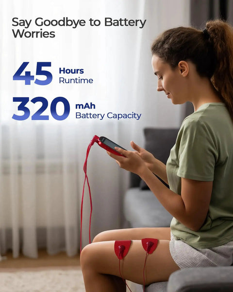 TENS unit muscle stimulator with two red adhesive pads on the thigh connected to a handheld controller