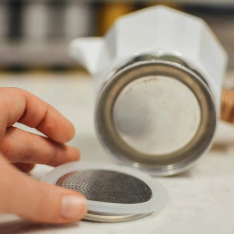 Close-up of a Milano Stovetop Espresso Maker Gasket Set with 3 Silicone Seals and 1 Replacement Filter Screen Kit for Moka Pots