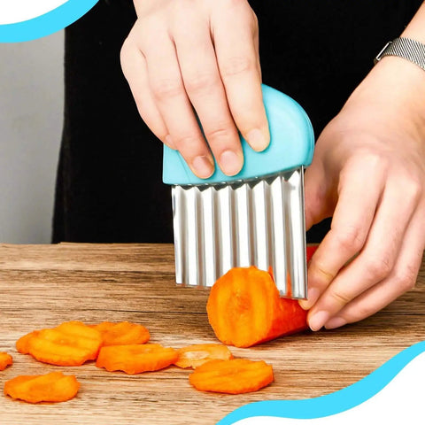 Person using blue stainless steel crinkle cutter on carrot slices, part of 2 piece set to make waffle fries and crinkle cut potatoes.