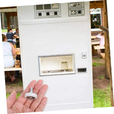 Hand holding track wheel in front of outdoor vending machine, showcasing 10 Piece Wear Resistant Beefed Up Track Wheels Set For Smooth Drawer And Cabinet Sliding, Heavy Duty Casters For Furniture, Industrial Equipment, And Vending Machines, Carbon Steel And Nylon Construction For Long Lasting Durability.