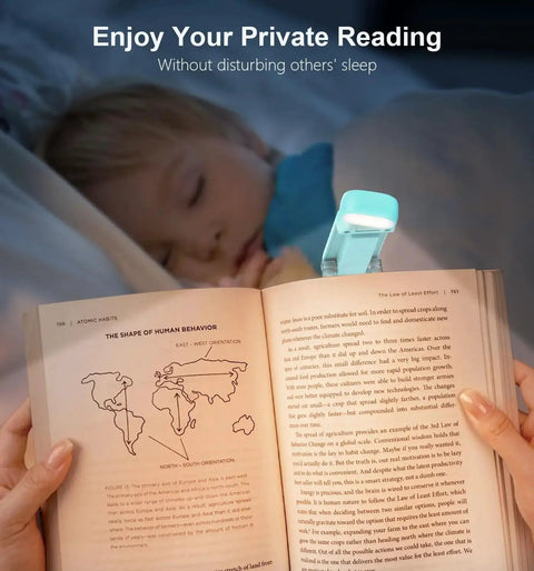 Rechargeable Clip On Reading Light With 3 Color Temps And 5 Brightness Levels clipped to a book, illuminating pages at night.