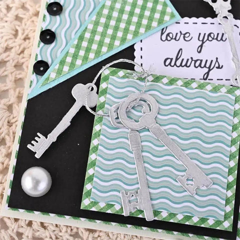 9 Piece Vintage Keys Metal Cutting Dies Set for Scrapbooking and Card Making displayed on a craft card with decorative paper