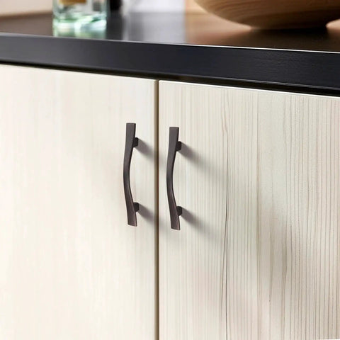 15 Pack Curved Oil Rubbed Bronze Cabinet Pulls, 3 Inch Hole Spacing on wood cabinet doors, shown in use, vintage dresser drawer handle style.