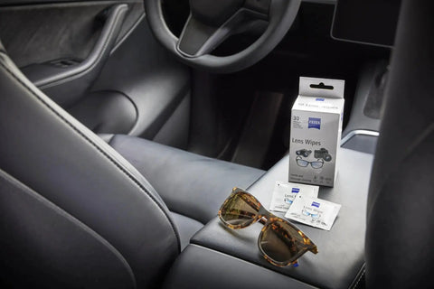 ZEISS Premium Sunglasses Wipes Pre Moistened 120 Count Safe For All Lenses box on car seat with sunglasses.