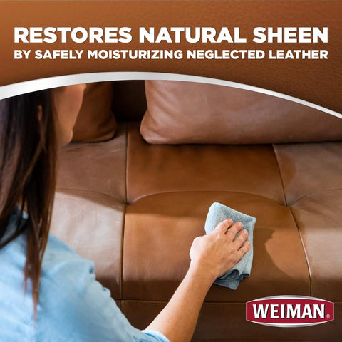 Person using Leather Care Wipes With Microfiber Cloth For Quick Easy Cleaning Conditioning And UV Protection To Keep Leather From Cracking Or Fading On Couches Car Seats Shoes Weiman 2 Pack on a leather couch.