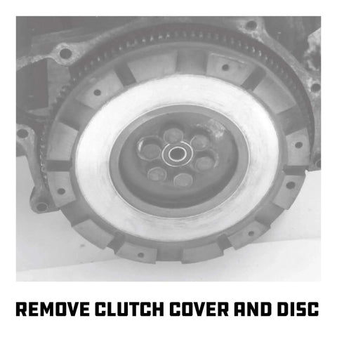 Flywheel with clutch cover removed for pilot bearing puller use, showing positive engagement design for secure bearing removal.