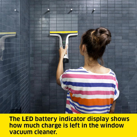 Kärcher WV 6 electric window vacuum squeegee in use on shower tiles; gray body with yellow 11-inch head.
