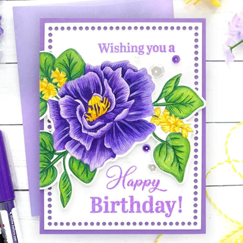 Handmade birthday card with purple flower illustration and 'Wishing you a Happy Birthday!' message on violet background.