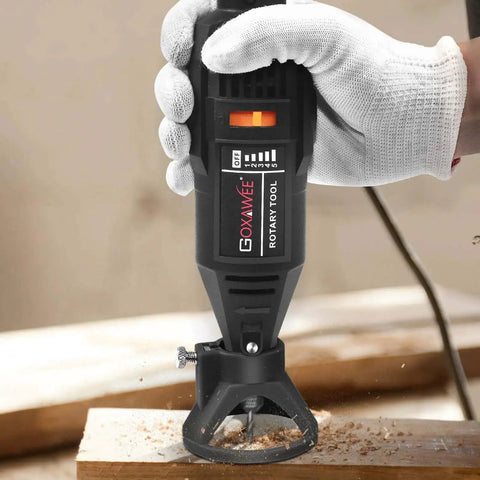 Versatile Rotary Tool Kit With Keyless Chuck and Flex Shaft in use on a wooden surface, demonstrating variable speed control.