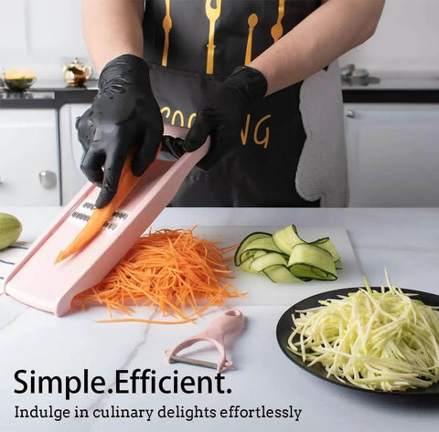 Person using Pink 5 In 1 Mandoline Slicer For Veggies And Potatoes With Peelers Graters And Waffle Fry Cutter Easy Prep Tool for slicing carrots.