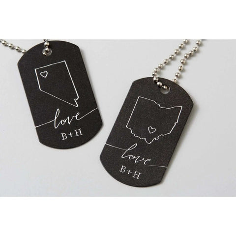 Two engraved metal tags with outlines of states, love and initials, created with Pro Grade Engraving Tip With QuickSwap Housing