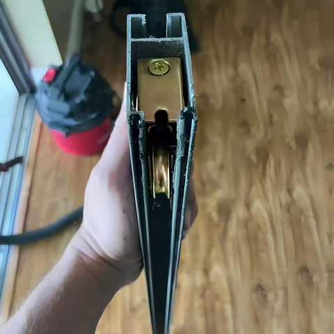 Side view of a Sliding Patio Door Roller Assembly with 1-1/8 inch steel wheel in track housing, dichromate finish for doors.