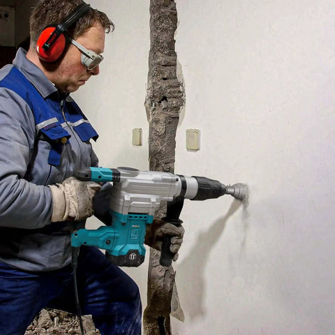 Man using a rotary hammer with Heavy Duty 2 Inch By 9 Inch SDS Max Core Drill Bit For Concrete By Berserker on a wall.