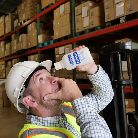 Worker using Sterile Isotonic Buffered Eye Wash For Flushing And Irrigation 16 Oz Bottle in warehouse setting