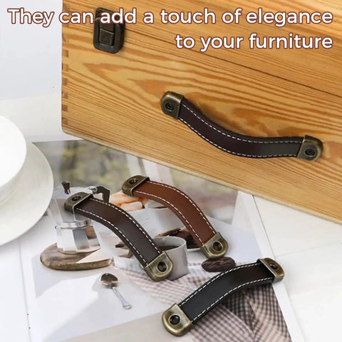 Image of a three piece leather wrapped drawer and cabinet handles set in brown zinc alloy finish with built in screws retro wardrobe door handles for dressers and cabinets 18 cm long adjustable leather grip hardware soft to the touch for comfortable grip and smooth placed on a wooden drawer showcasing their design and versatility.