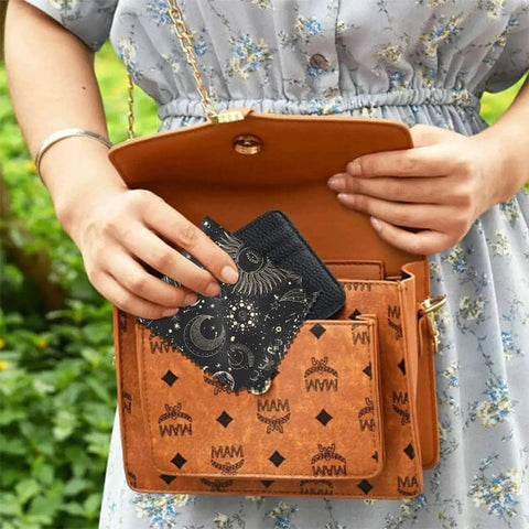 Woman placing Six Pack Microfiber Cleaning Cloths For Eyeglasses And Devices Moon Star Pattern in a handbag