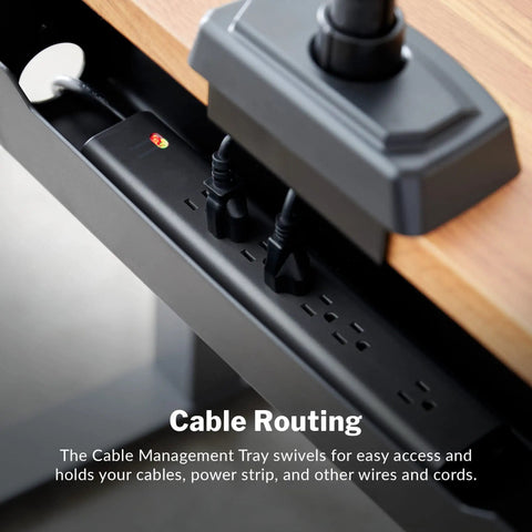 Under Desk Cable Management Tray For Sit Stand Desks, black tray holding cables and power strip under a wooden desk.