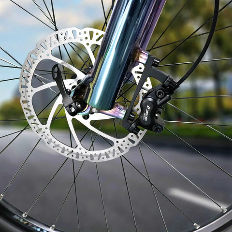 Z00M hydraulic brake caliper and disc rotor installed on front e-bike wheel; black caliper, silver rotor