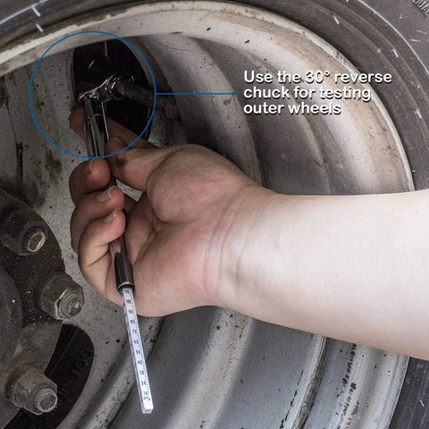 Silver pencil tire pressure gauge with metal stem being used on a car wheel to measure tire pressure.