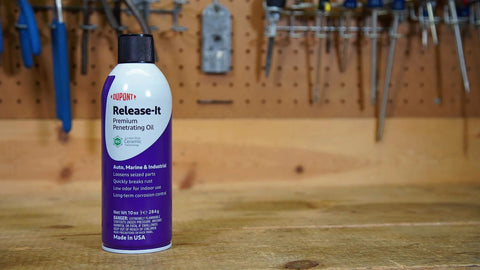 Stuck Bolts And Nuts Teflon Penetrant Aerosol 10 Oz can on workbench with tools in background, rust protection for hardware.