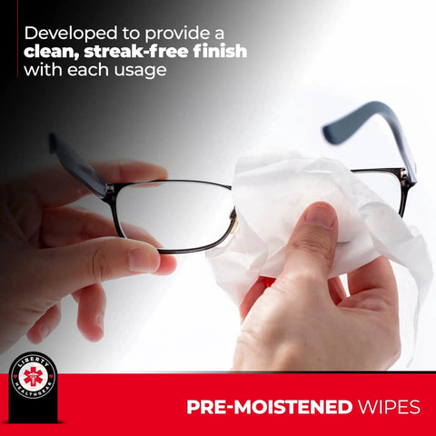 Person cleaning glasses with Premoistened Eyeglass Wipes With Microfiber Cloth For Glasses Lenses And Screens