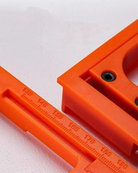 Close-up of 5.5-Inch Hidden Hinge Mortiser Template in orange, showing detailed markings for precision door installation.