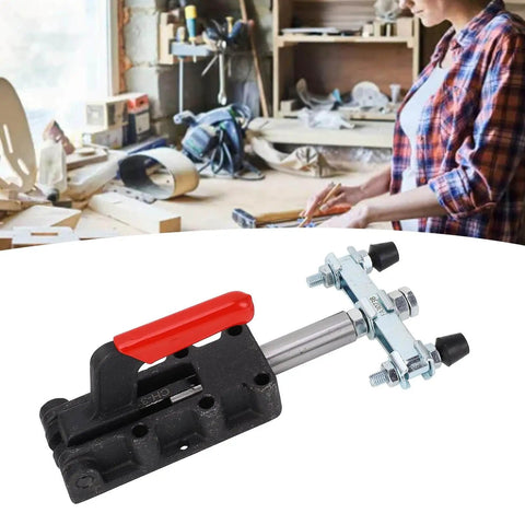 Double Headed Push Pull Quick Release Toggle Clamp with red plastic handle on cast iron base in woodworking shop.