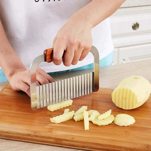 Stainless Steel Crinkle Cutter With Wooden Handle, Heavy Duty Wavy Blade Slicer For Potatoes, Carrots, And Veggies in use on potato