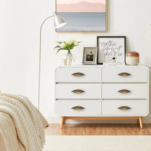 White dresser with Six Pack Antique Brass Cabinet Pulls Made From Zinc Alloy For Kitchen Drawers Dressers And Cupboards With Five And One Eighth Inch Total Length And Two And A Half Inch Center To Center Screw Spacing For Easy Installation And An Elegant Vintage Look in modern bedroom decor.