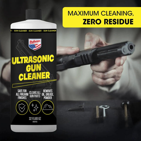 Front view of a plastic Ultrasonic Gun Cleaner bottle (32 oz) with black label and yellow text; gun parts in background.
