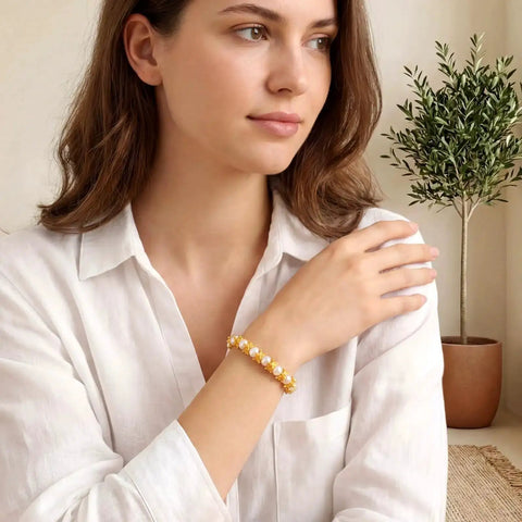 Woman wearing bracelet with Gold Mini Crown Charms 100 Pieces, 3D Vintage Alloy Queen King Crowns Beads, on white blouse background