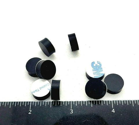 One Half Inch Round Silicone Rubber Bumper Feet Three Sixteenths Of An Inch Thick Adhesive Backed Spacer Pads scattered on surface