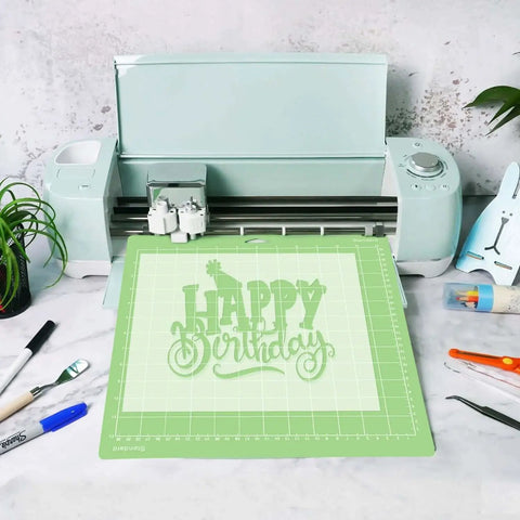 12x12 Inch Standard Green Grip Cutting Mat for Cricut Explore One Air Air 2 Maker 8 Pack Non Slip Adhesive Replacement Mats Compatible With Vinyl Paper Cardstock Thin Fabric And Other Medium Weight Materials shown in use with a 'Happy Birthday' design on a cutting machine.