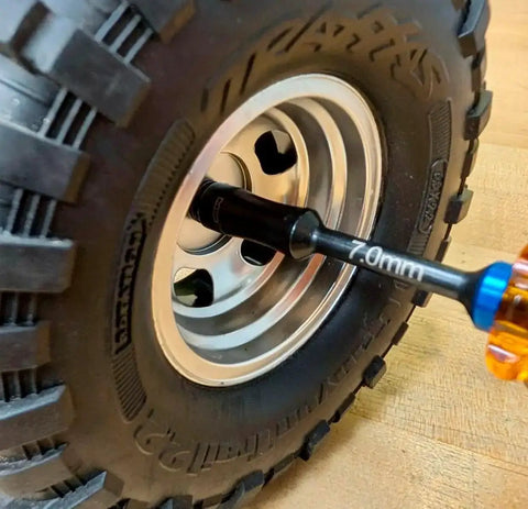 Close-up of Gen 2 Amber Handles Hex Driver Set Three Pack For Precision RC Tools and Electronics, removing 7.0mm hex nut on wheel.