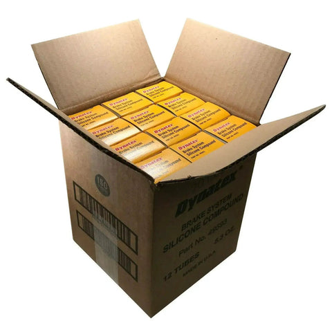Open box showing 12 tubes of Dynatex Brake System Silicone Lubricant Compound 5.3 Oz Tube For Auto And Marine Use Pro Grade Formula Prevents Squeaks And Wear Protects Rubber And Plastic Gears Made In USA Boxed Tube Trusted By Midas And Meineke Shops.