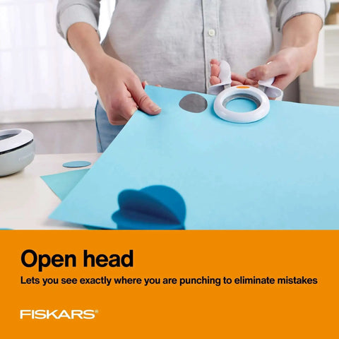 Person using X Large Craft Hole Punch with Ergonomic Easy Squeeze Grip on blue paper for precise clean cuts in scrapbooking
