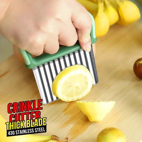 Close-up of hand using a Two Pack Stainless Steel Wavy Crinkle Cutters For Veggies And Fries Durable Home Kitchen Tool on lemon slice
