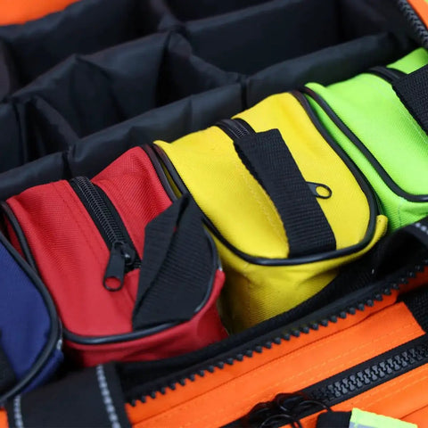 Color Coded First Aid Kit Pouches Set of 4 With Transparent Window For EMT Trauma Bags, shown inside a large open trauma bag.
