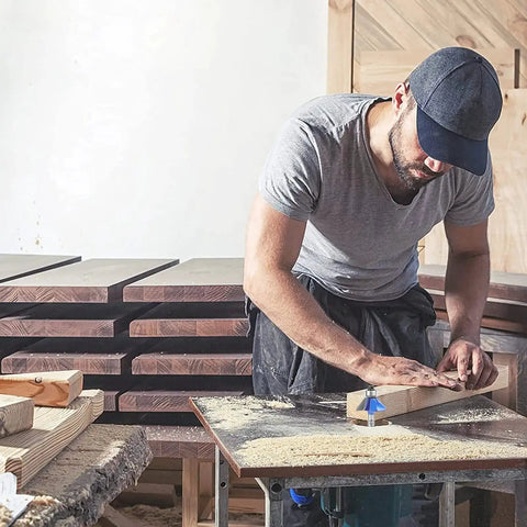 Woodworker using 45 Degree Chamfer Router Bit Set for Smooth Angled Edges, 4 Piece, 1/4 Inch Shank on wood piece in workshop